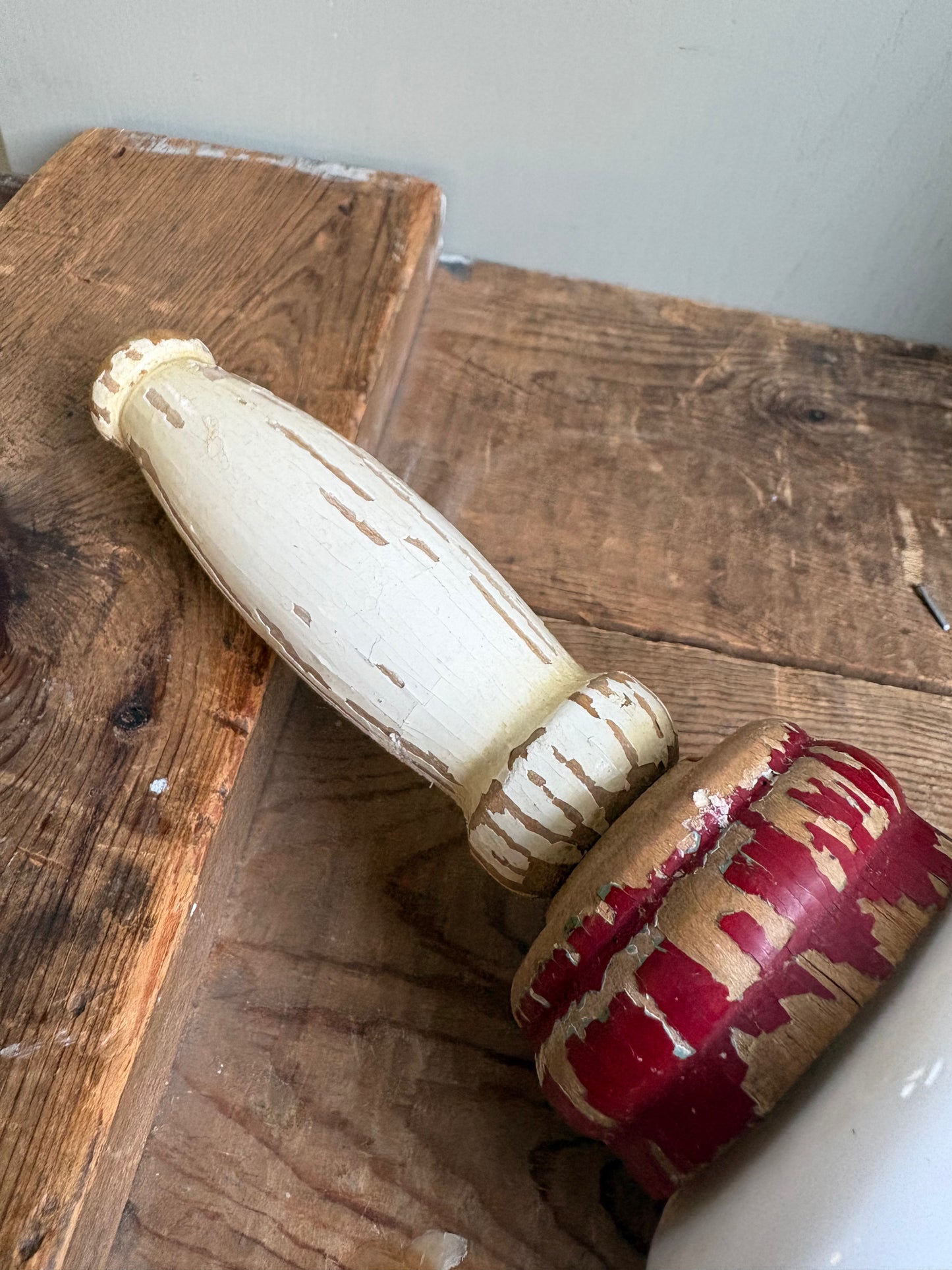Close up of wooden handle of vintage rolling pin on wood board