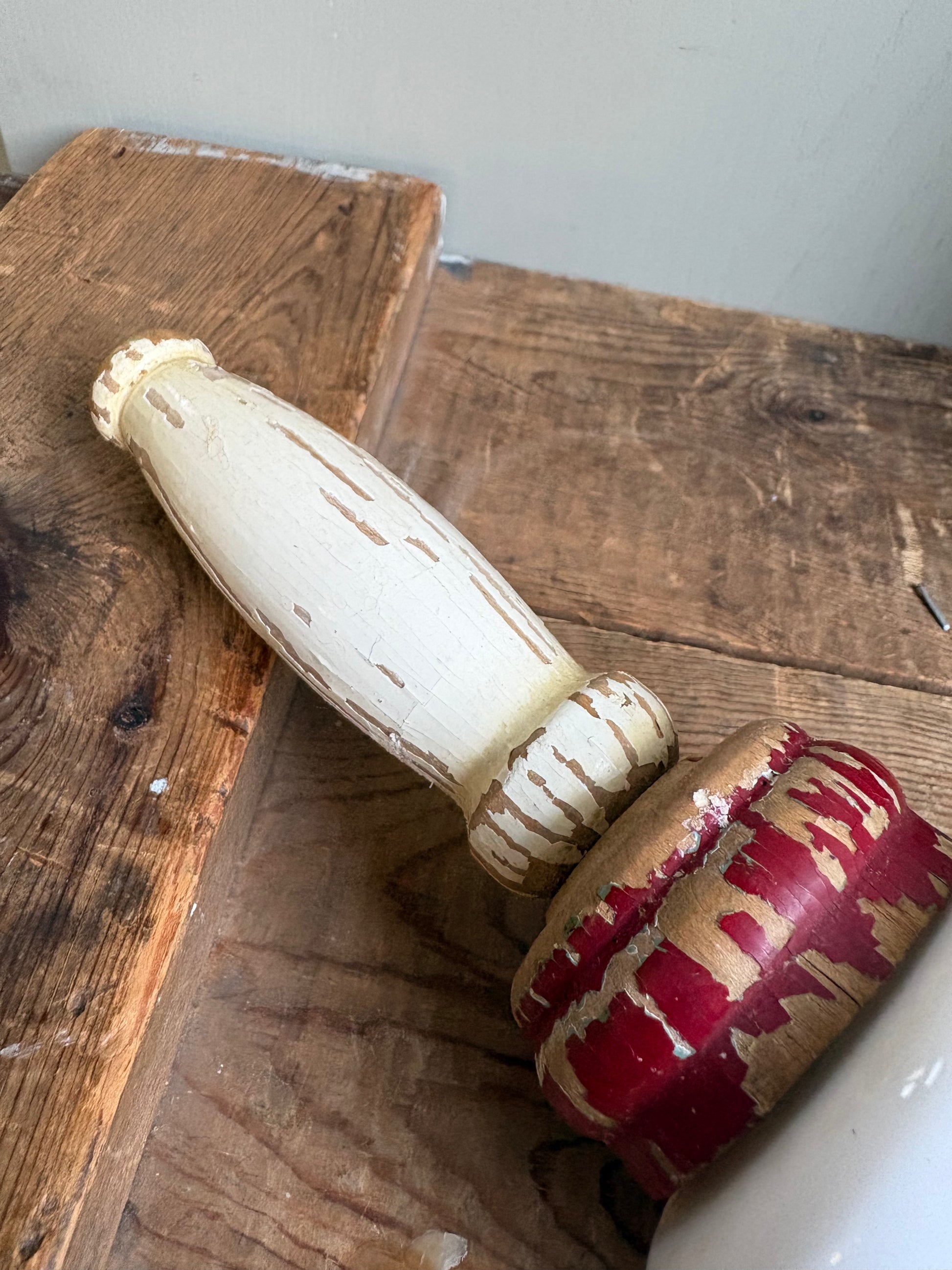 Close up of wooden handle of vintage rolling pin on wood board