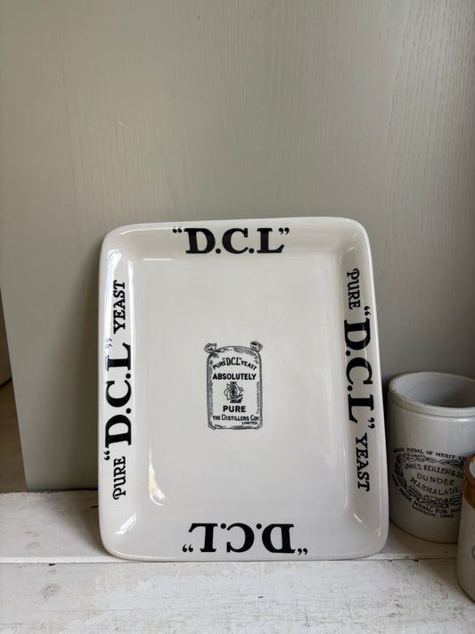 Early 20th century English ironstone DCL Yeast advertising shop counter display plate with black typography graphics.
