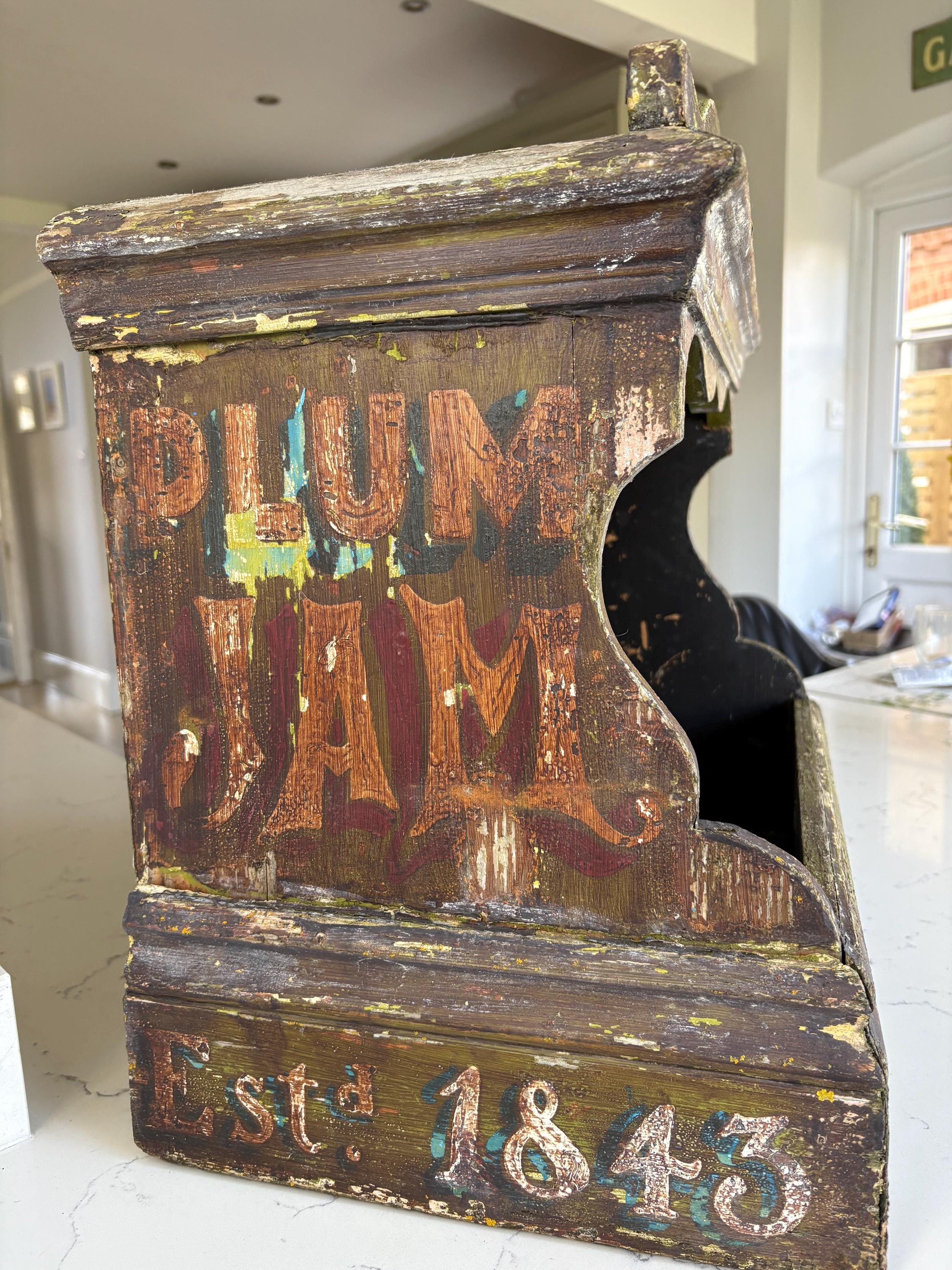 A vintage shop display for jam with five stone pots.